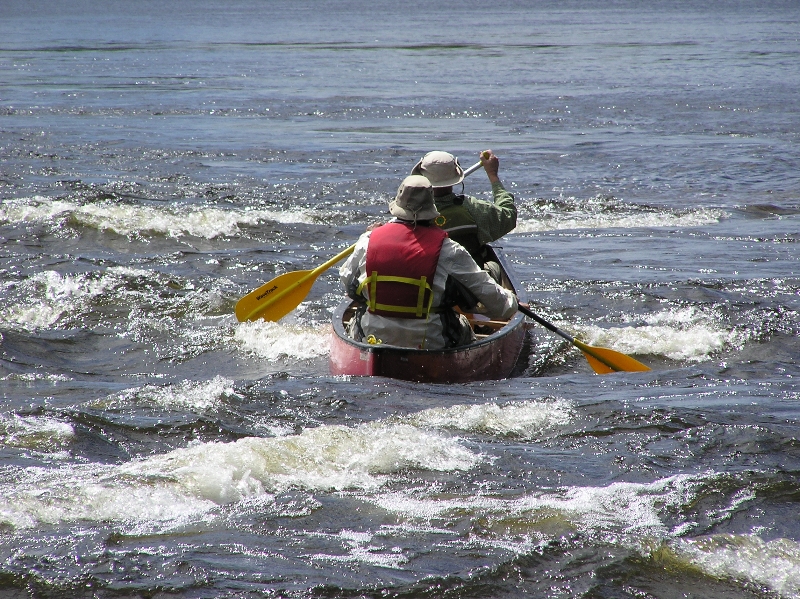 Two paddlers in a canoe on the river
